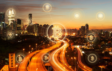 Bitcoins and blockchain network connection with night city background .Electronic money ,blockchain transfers and finance concept.