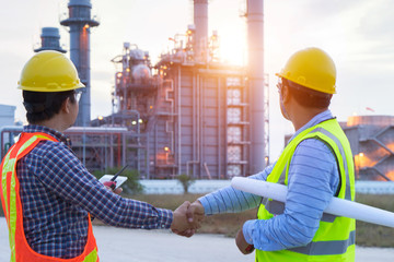 Industrial engineering working in a power plant, teamwork twilight