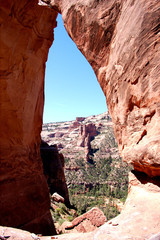 Massive red rock arch and monument and blue sky in the Bears Ears wilderness in Southern Utah.