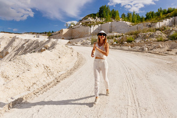 young girl in white runs on a loose road