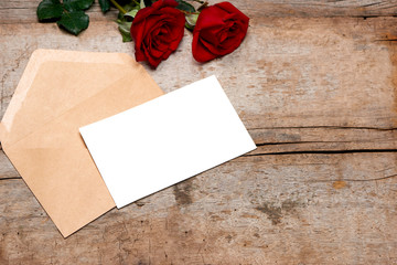 Letter for Mom with rose and in envelope on wooden background