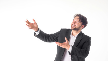 Happy smiling young man with a phone presenting and showing your text or product isolated on white background.