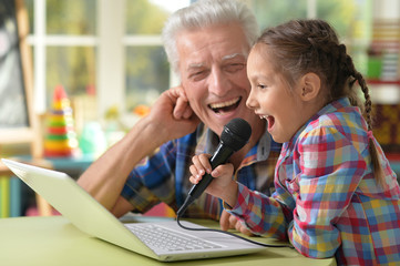 grandfather and child singing karaoke