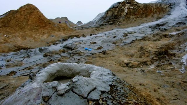 Boiling muddy bubbles in crater of mud volcano of Gobustan near Baku, Azerbaijan, v02