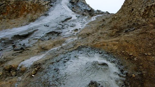 Boiling muddy bubbles in crater of mud volcano of Gobustan near Baku, Azerbaijan, v03