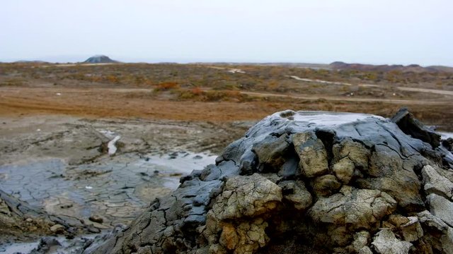 Boiling muddy bubbles in crater of mud volcano of Gobustan near Baku, Azerbaijan, v04