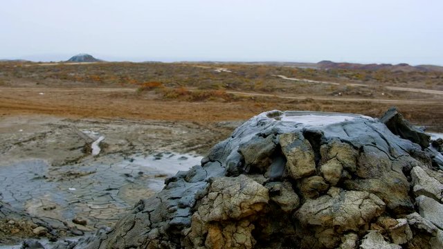 Boiling muddy bubbles in crater of mud volcano of Gobustan near Baku, Azerbaijan, v05