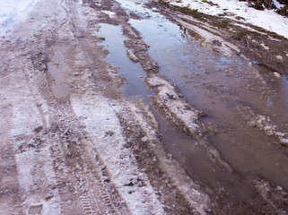 Snow melts on the road as a background