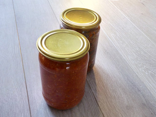 Canned food in a jar pickled salads two pieces on the table