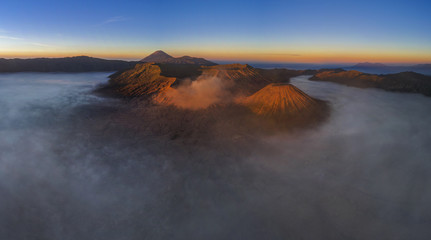 Aerial Panoramic view of Mount Bromo covered with mist at sunrise, indonesia