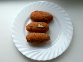 Chicken cutlets on a plate on a white background