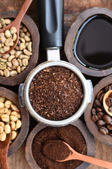 Close up of coffee beans and ground coffee in wooden bowl