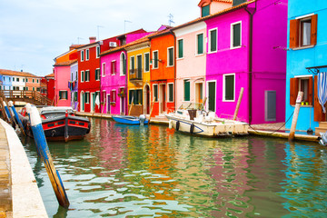 Multicolored walls of houses and motor boats on Burano island, Venice