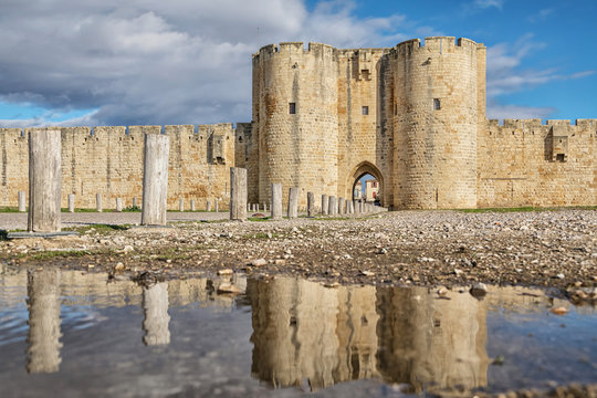 Aigues-Mortes, France. Main Gate in southern wall reflecting in water