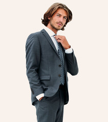 Fototapeta premium businessman straightening his tie isolated on a white background