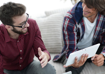 two creative web designers working with a tablet and a laptop.