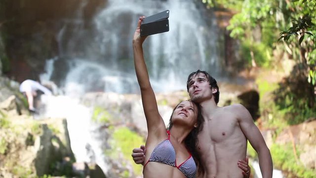 Travel happy couple fun taking selfie photo by waterfall on Koh Samui, Thailand, 1920x1080