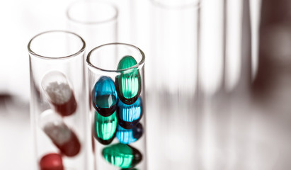 Laboratory Microscope, pills and test tubes. Scientific and healthcare research background.