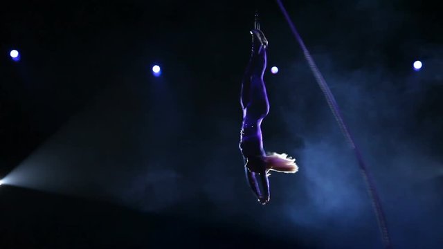 Acrobat with rope in circus