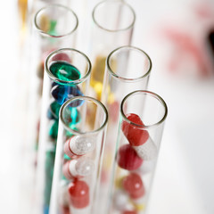 Laboratory Microscope, pills and test tubes. Scientific and healthcare research background.