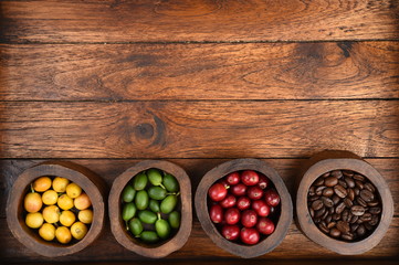 Coffee beans and fresh berries beans on wooden background