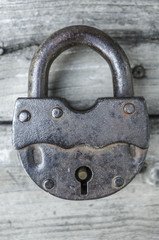 Padlock on an old wooden table top