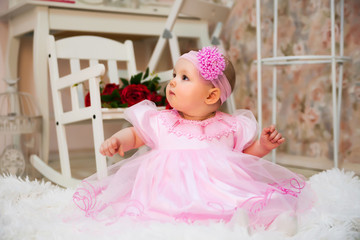  10-month-old girl in   festive dress in   studio.