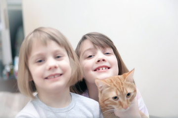 Fototapeta na wymiar two girls with cat
