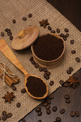 Coffee beans in a wooden box, buckwheat and cinnamon sticks.