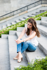 sad girl sitting on the stairs