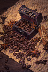 Coffee beans in a trunk, buckwheat and cinnamon sticks.
