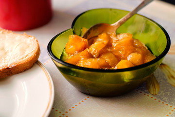 Bowl with apple jam on a table