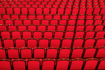 Empty red chairs in concert hall