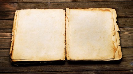 Vintage open book with soft shades on wood