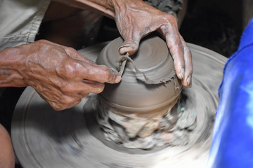 closeup on potter man hands shaping ceramic craft, ko kret island, Nonthaburi, Thailand