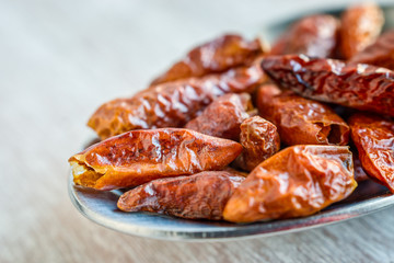 Small dried chilli peppers. Macro detail.