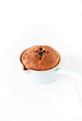 Traditional German Easter Bread, Osterbrot, made of Brioche yeast dough with raisins, eggs, milk, flour, yeast, sugar and butter baked in small saucepan served for Easter Sunday breakfast or brunch
