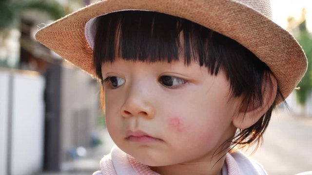 slow-motion, cute child eyes looking question around himself with beautiful soft sunlight scene