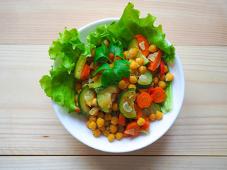 Vegan lunch bowl of salad with zucchini and chickpea.
