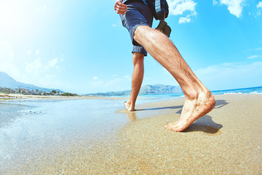 man walks along the empty beach