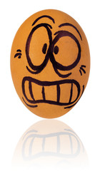 Easter egg, painted in a terrified cartoon funny face of a guy. Decorated scared egg in a natural yellow color.