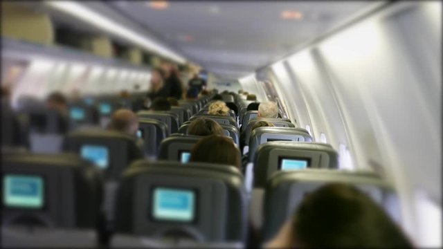 Passengers fly on the crowded and bumpy airplane while travelling