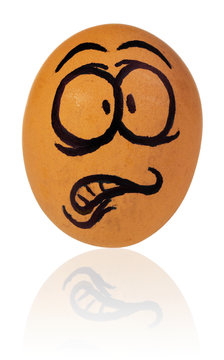 Easter egg, painted in a terrified cartoon funny face of a guy. Decorated scared egg in a natural yellow color.
