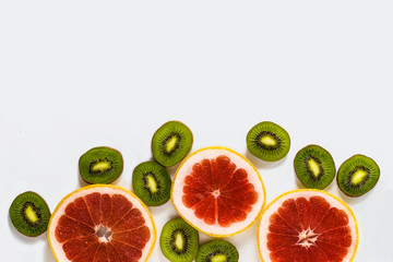 Cut fresh fruit, kiwi and grapefruit on a white background