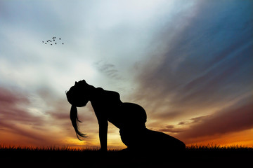 Fototapeta na wymiar a pregnant girl doing yog at sunset