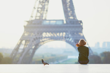 Beautiful young French woman near the Eiffel tower in Paris