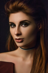 Close-up portrait of brunette woman with paper choker