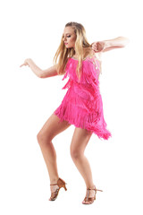 Naklejka premium Side view of elegant feminine sensual blonde female dancing in fringed pink dress. Full body isolated on white background.