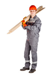 builder in a helmet holding wood boards and looking at camera over white wall background.
