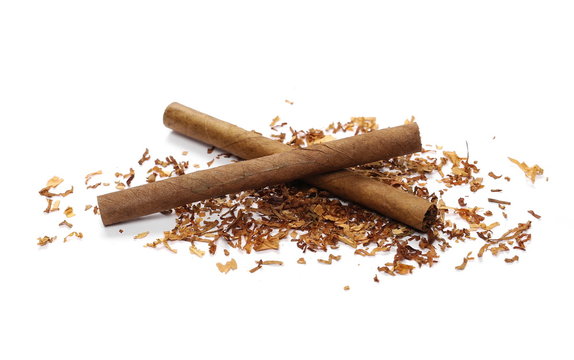 Cigarillos and tobacco pile isolated over white background